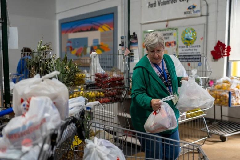Mary Fergerson puts bags in a cart.
