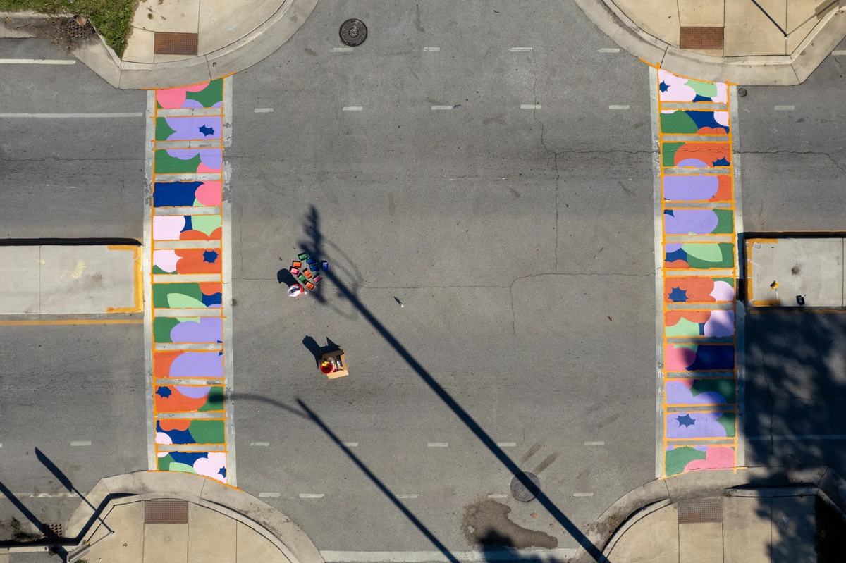 Two freshly painted crosswalks on North 40th Street during the “Paint the Pavement” event hosted by Rooted & Rising – Washington Park and Artists Working in Education.