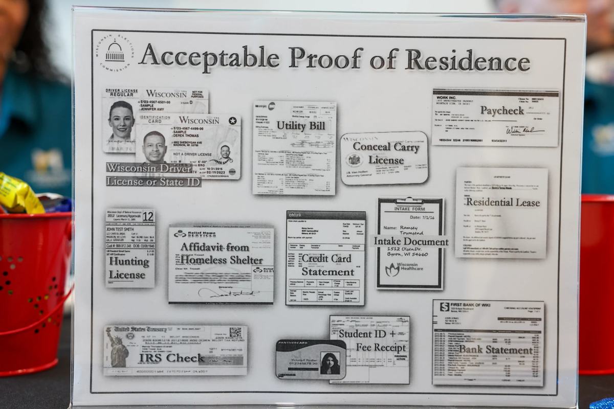 A sign showing the acceptable proof of residence documentation on display. (Photo by Jonathan Aguilar / Milwaukee Neighborhood News Service / CatchLight Local)