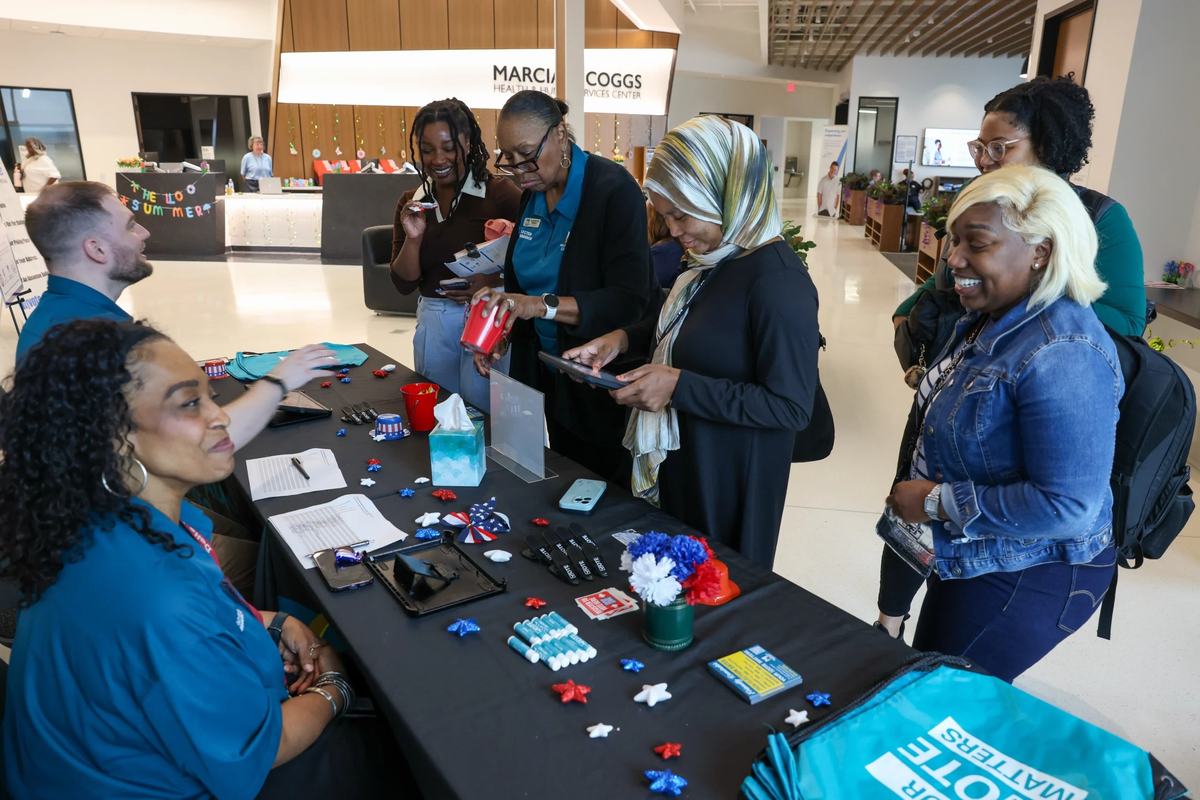 People check their voter registration status with the Milwaukee County Election Commission during a voter registration event at the Marcia P. Coggs Health and Human Services Center on Sept. 17. (Photo by Jonathan Aguilar / Milwaukee Neighborhood News Serv