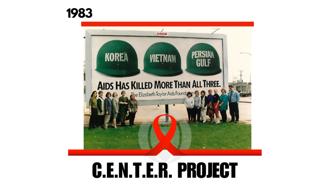 A photograph of the staff of the CENTER Project in front of a billboard in Green Bay in 1993. The billboard says Korea, Vietnam, Persian Gulf, aids has killed more than all three.