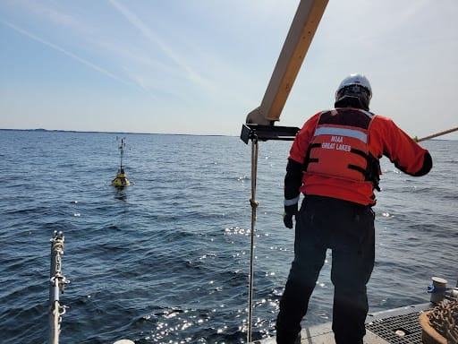 A member of NOAA monitors one of the Great Lakes buoys off the coast of Ludington. [Courtesy photo/Great Lakes Observing System]