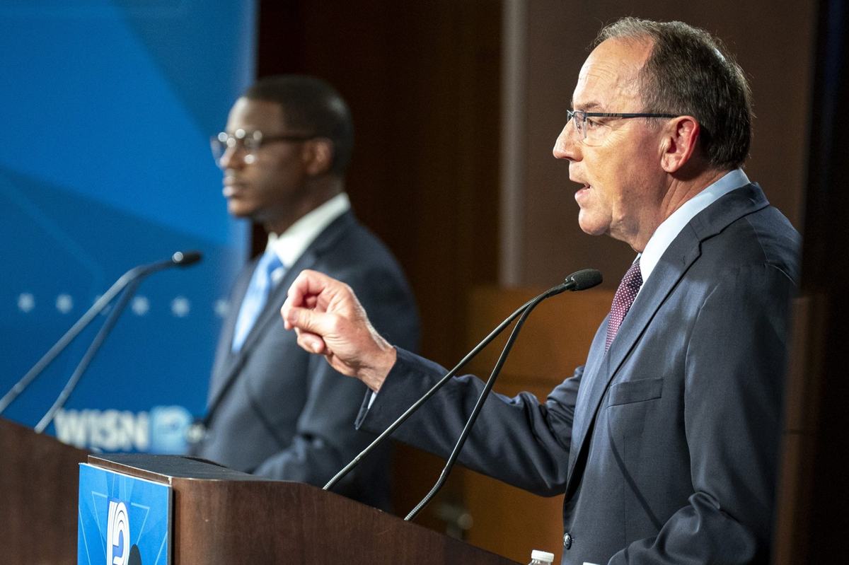 Side view of two men speaking at podiums