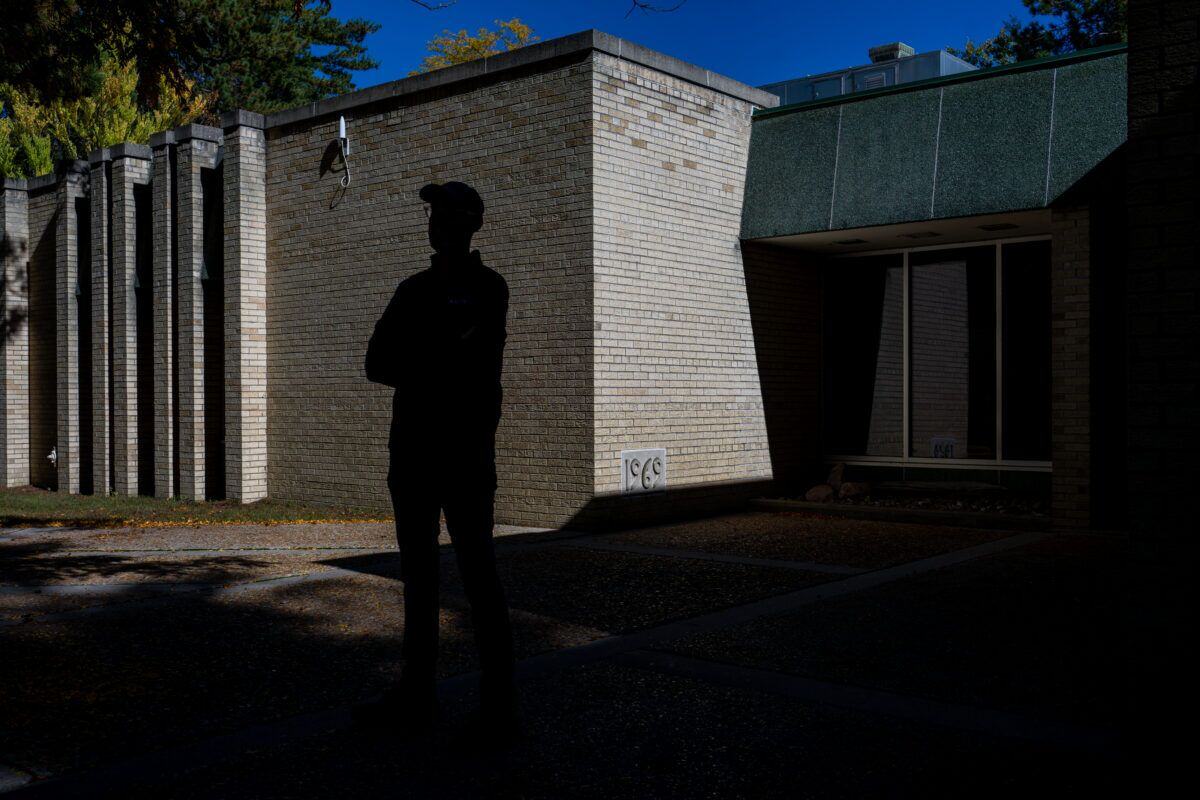 Kallgren stands silhouetted by UW-Marinette’s former Library Learning Commons, built in 1969. (Kara Counard)