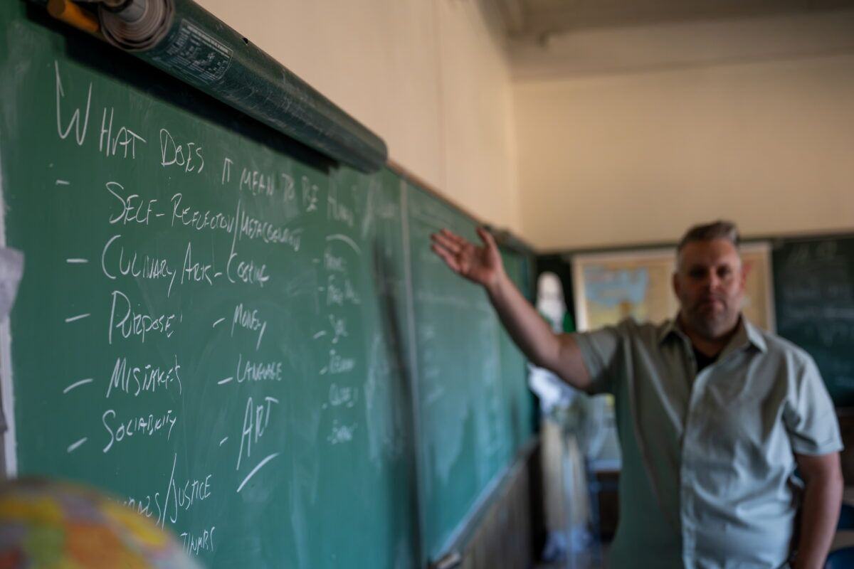 The chalkboard in Stevens’s classrooms asks: “What does it mean to be human?” (Kara Counard)