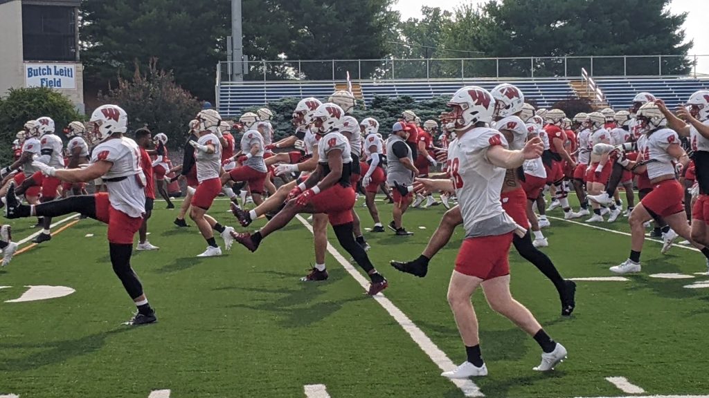 Wisconsin Badgers football players warm up at UW-Platteville during 2023 fall camp.