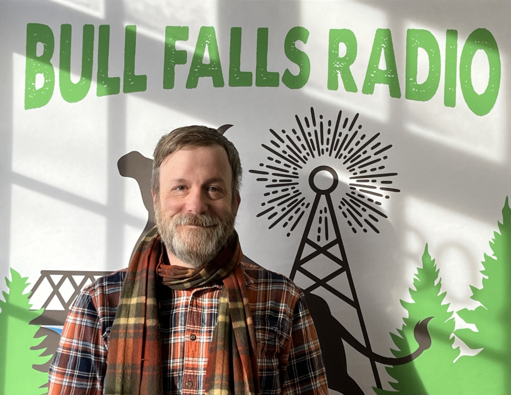 Chad Dally of the Marathon County Public Library with the Bull Falls Radio logo.