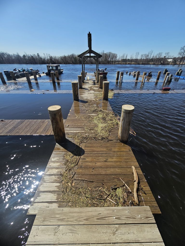 Wolf River swells over its banks, putting docks underwater in Spring of 2023.