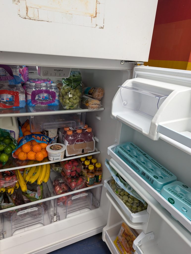 Refrigerator stocked with fruits, vegetables, drinks, eggs and more.