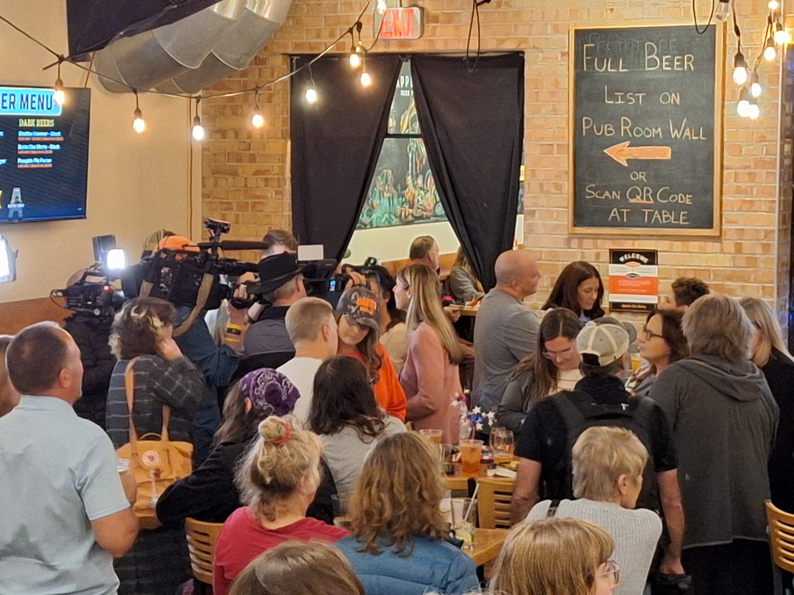 Dr. Kristin Lyerly chatting with attendees at the official Outagamie County Democratic Watch Party waiting for more results to come in at the Appleton Beer Factory.