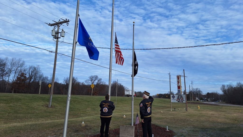 Two veterans raising the Memorial Flag on Pearl Harbor Day