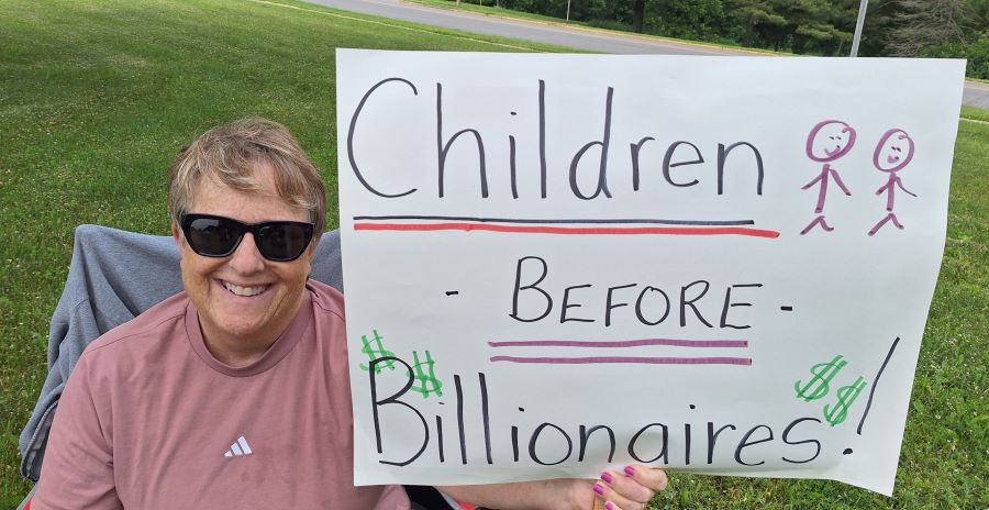 Sign reading Children before Billionaires
