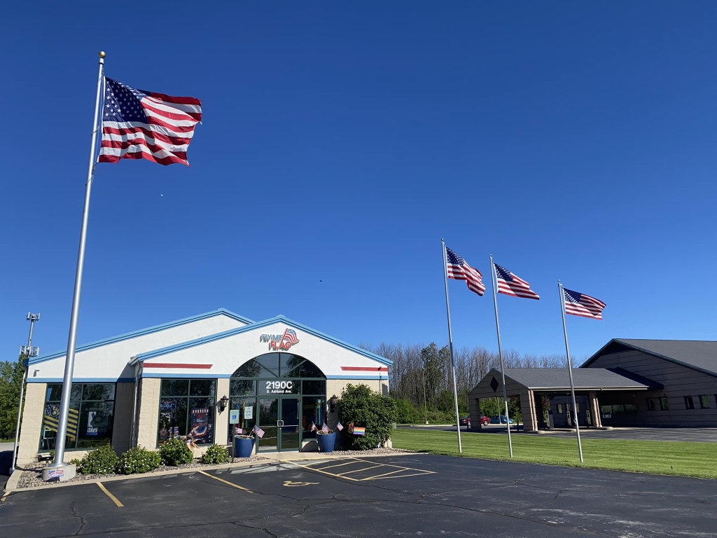 picture of Fly ME Flag's exterior building and parking lot.