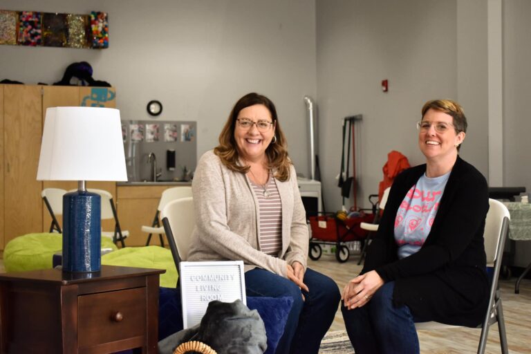 Community Living Room Founders Lynn McLaughlin and Karen Iverson Riggers sitting in the Community Living Room.
