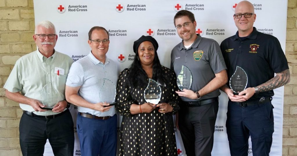 Photo of Jeff Rabas, Rick Leib, Dominique McQueen, Dan Kane and Fond du Lac Fire Chief Erick Garritson holding American Red Cross Plaques for 2025 Heroes.