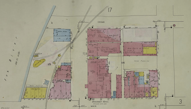 A map shows color-coded building outlines, labels for streets including Cedar and Main, and the Fox River along the left edge.